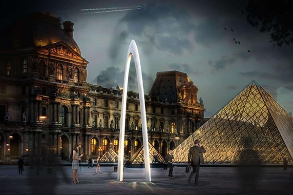 INJ Architects photomontage of the Plastic Arc monument rendered as a small white twin limb form inserted into a wide angle photograph of the Louvre courtyard under overcast sky with the glass pyramid at center and the palace facade to the right