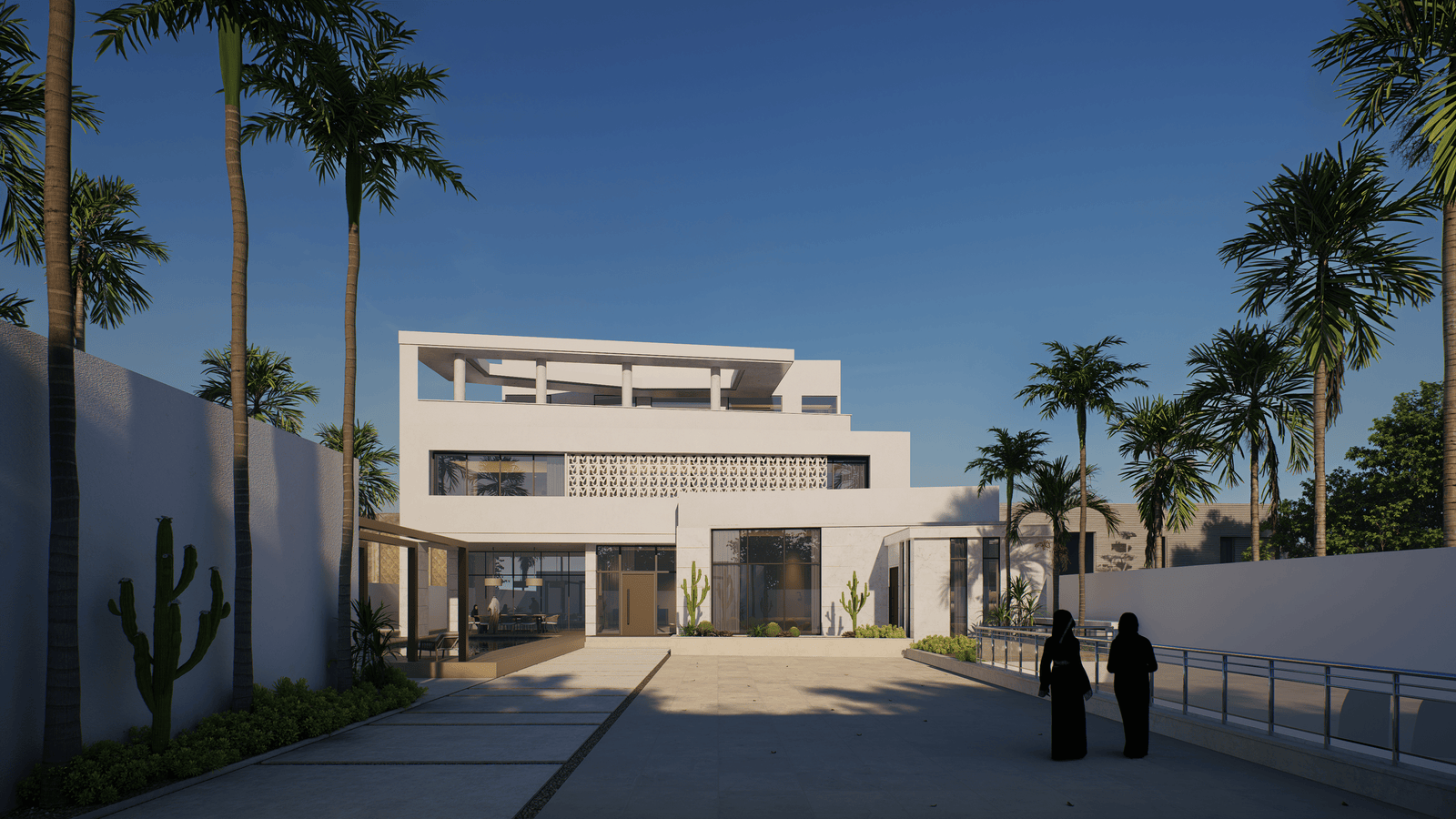 INJ Architects daytime view showing a wide paved approach flanked by palm trees leading two people in abayas toward a white stepped multi level residence in Al Murjan