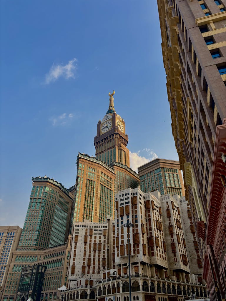 Stunning view of the Abraj Al Bait Towers in Mecca under a clear blue sky.