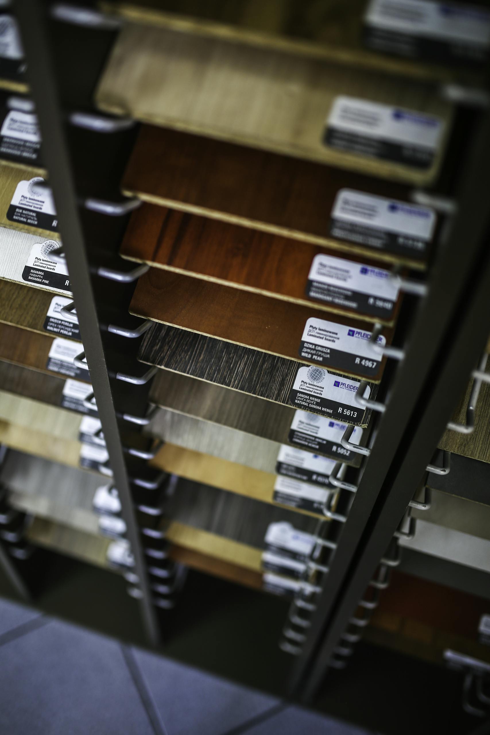 A collection of laminated wood samples organized in a vertical display rack for selection.