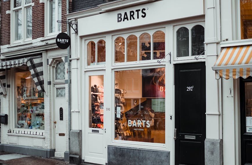 A cozy urban storefront with unique architecture and welcoming signage captured on a rainy day.