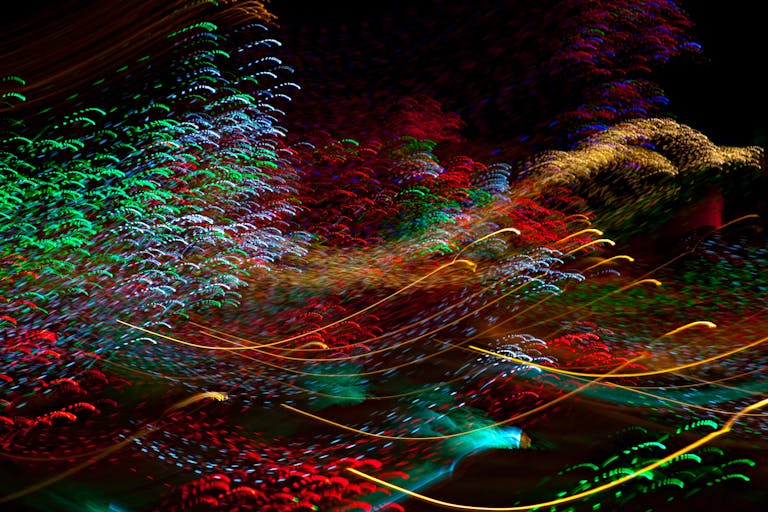 Dynamic long exposure capturing colorful light trails in an abstract display.