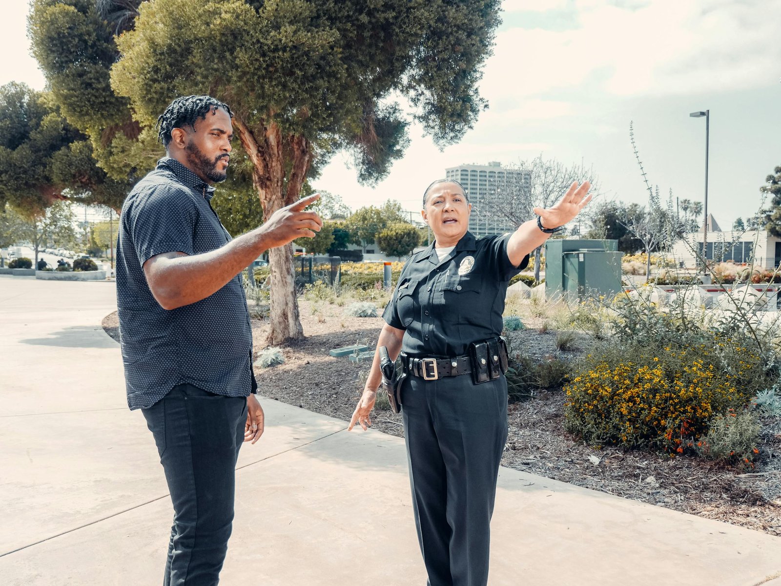 Police officer speaking with a man outdoors, showcasing community engagement.