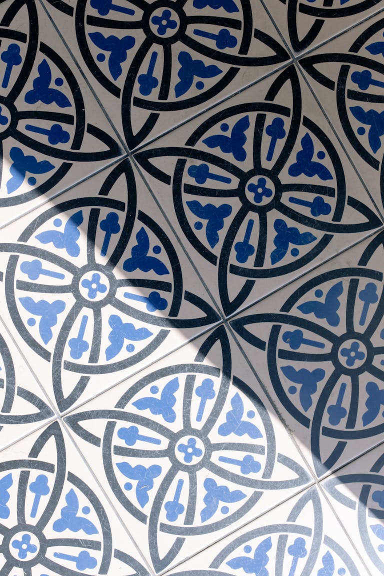 Artistic blue and white mosaic tile design with shadow overlay, creating a captivating pattern.