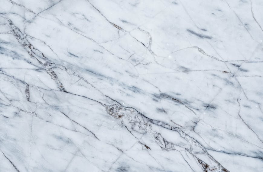 High-resolution white marble texture with gray veining, ideal for backgrounds and design projects.