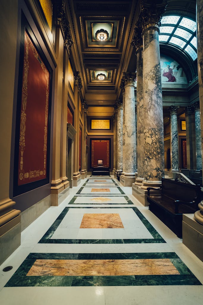 Stunning museum interior featuring ornate marble columns and decorative ceiling.
