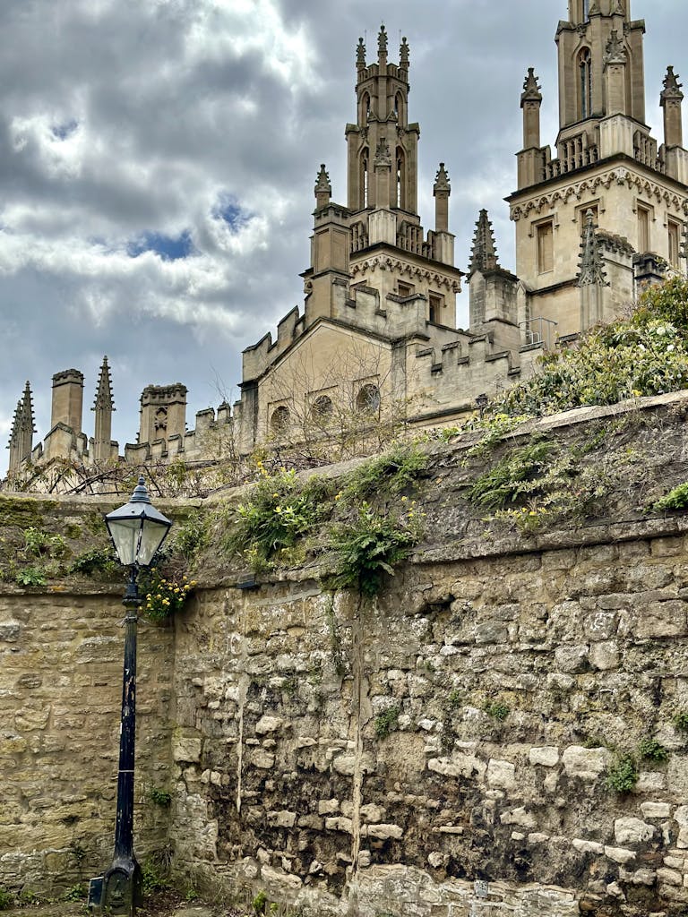 A captivating view of Oxford University's iconic Gothic architecture with cloudy sky backdrop.