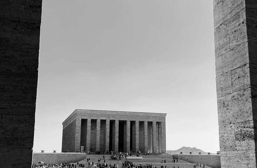 A striking black and white view of Anıtkabir with visitors on a sunny day in Ankara, Türkiye.