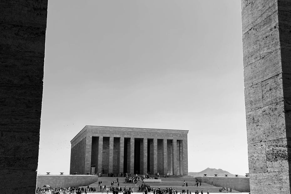 A striking black and white view of Anıtkabir with visitors on a sunny day in Ankara, Türkiye.