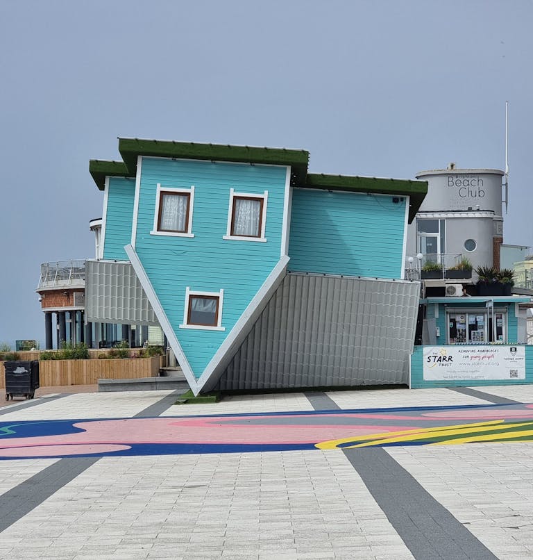 Unique upside down house attraction in Brighton, England, showcasing creative architecture.