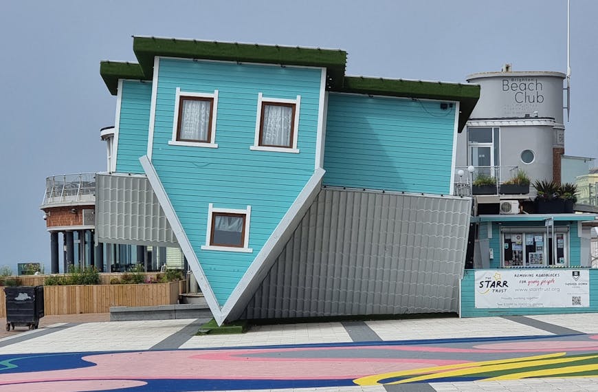 Unique upside down house attraction in Brighton, England, showcasing creative architecture.