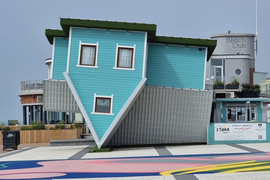 Unique upside down house attraction in Brighton, England, showcasing creative architecture.