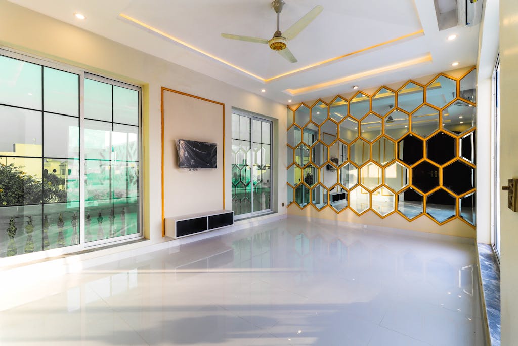 A luxurious modern interior with honeycomb mirrors, large windows, and sleek design.