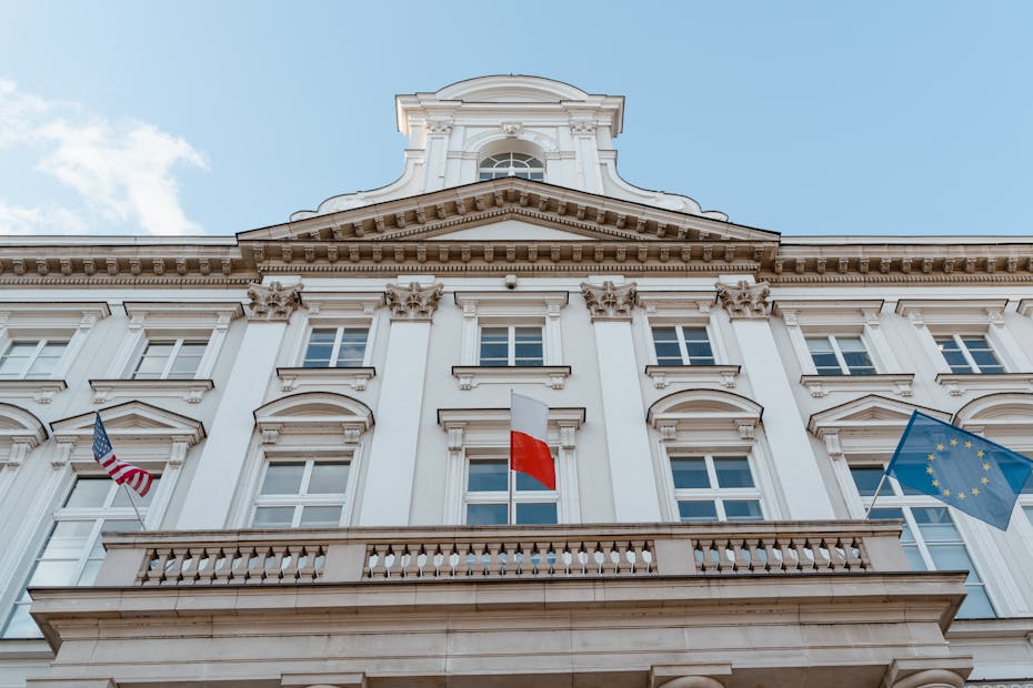 A classic architectural facade with multiple flags, showcasing international representation.