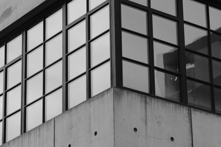 Monochrome photo of a modern glass and concrete building facade in New York.
