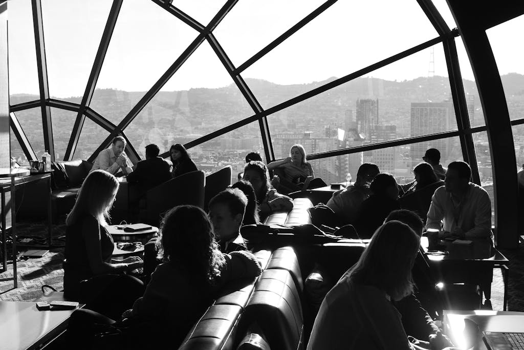 Black and white photo of people socializing in a stylish San Francisco lounge.