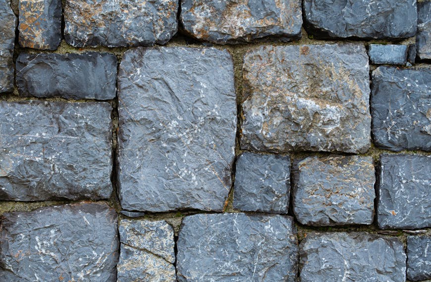Close-up of a rustic stone wall showcasing texture and earthy tones.