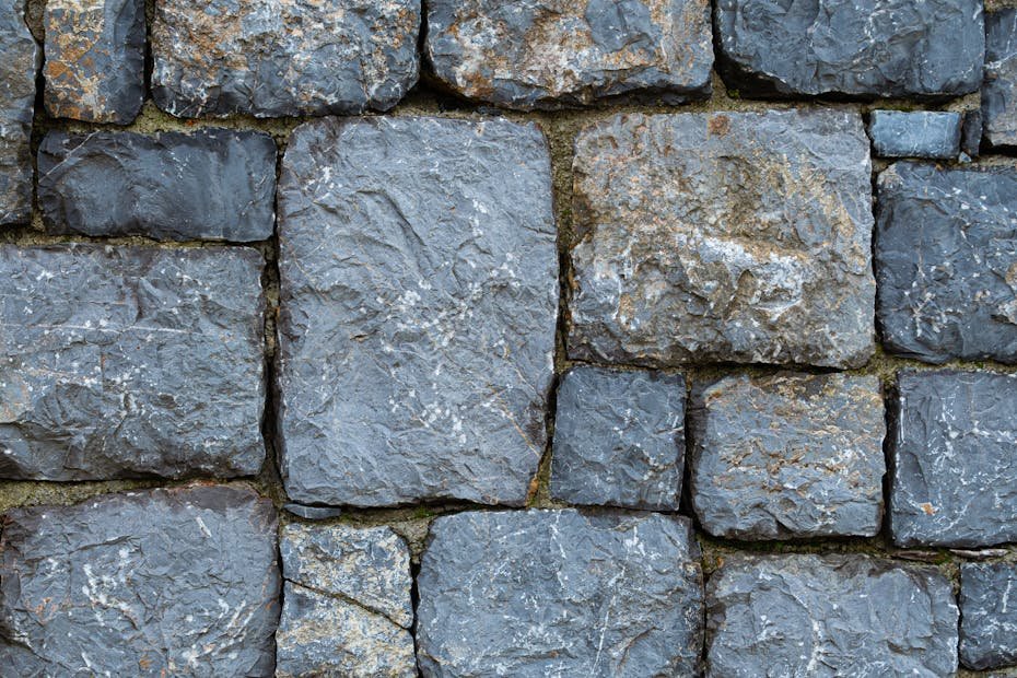 Close-up of a rustic stone wall showcasing texture and earthy tones.