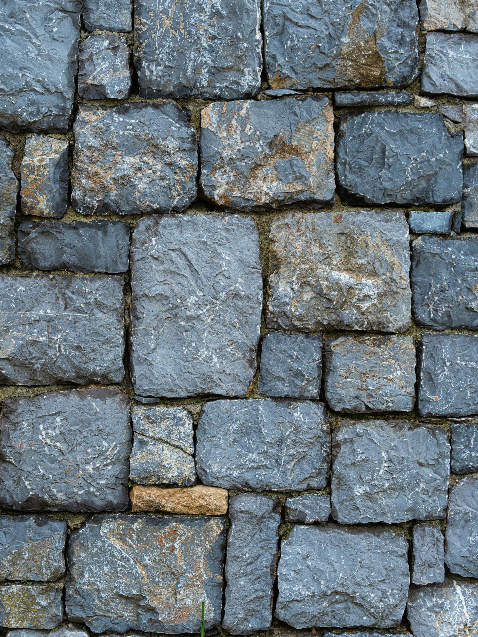 Close-up of a rustic stone wall showcasing texture and earthy tones.