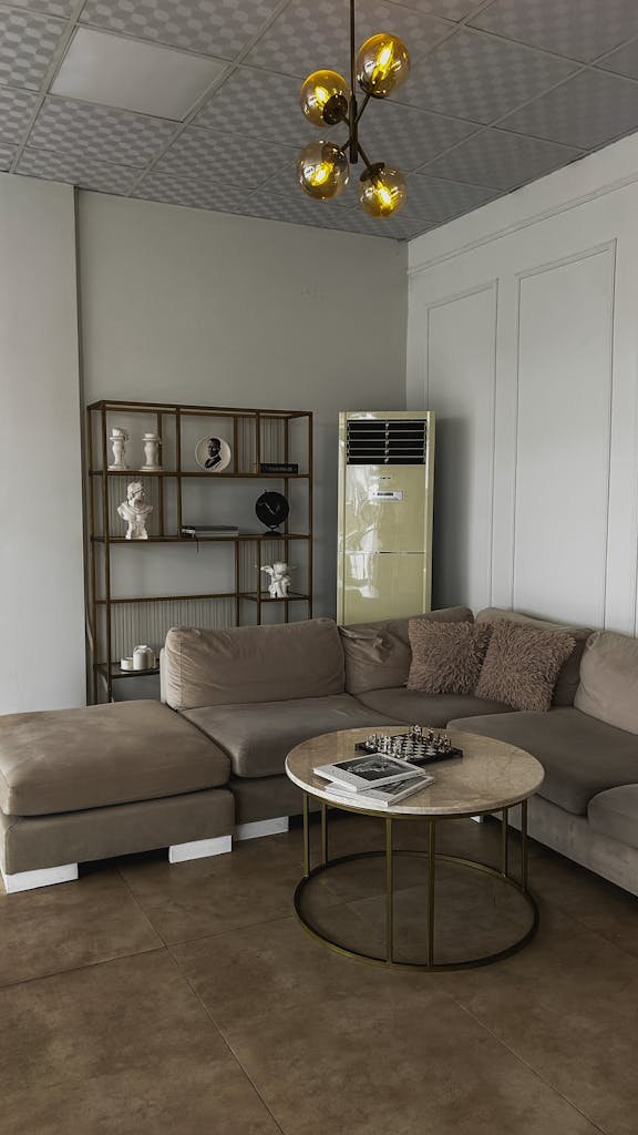 Contemporary living room featuring a brown sectional sofa, round coffee table, and stylish decor.