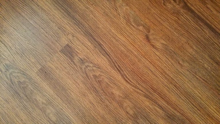 Detailed image of rustic wooden flooring with visible wood grain texture.