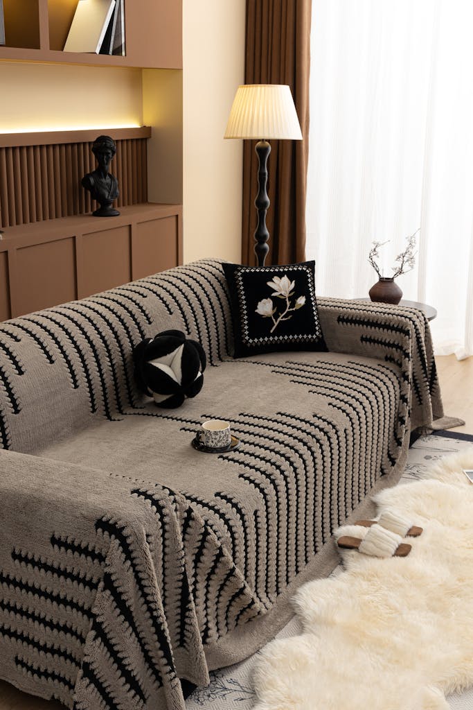 Elegant living room with a striped sofa throw, creating a cozy atmosphere.