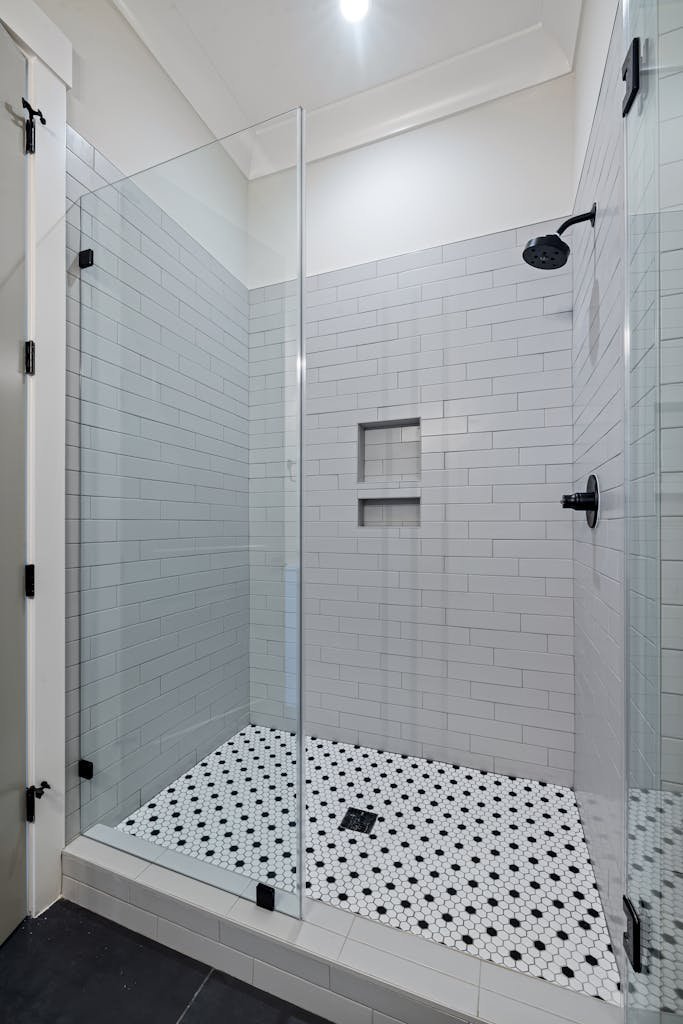 Explore a sleek modern shower in a luxury minimalist bathroom with high-end features.