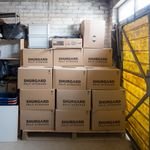 A stack of storage boxes in a well-organized warehouse interior.