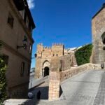 Elevated architectural survey of Toledo, Spain, capturing the high-density urban morphology, historical stone buildings, terracotta roofscapes, and medieval street layout influenced by Andalusian architecture.